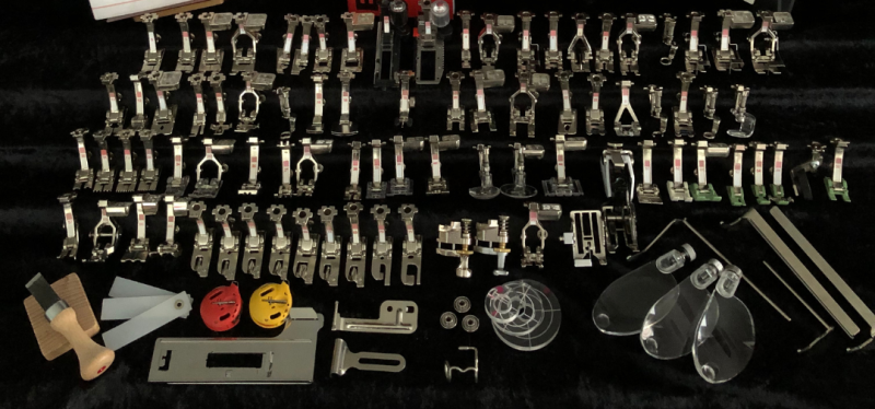 Close up picture of seventy-four different sewing machine feet